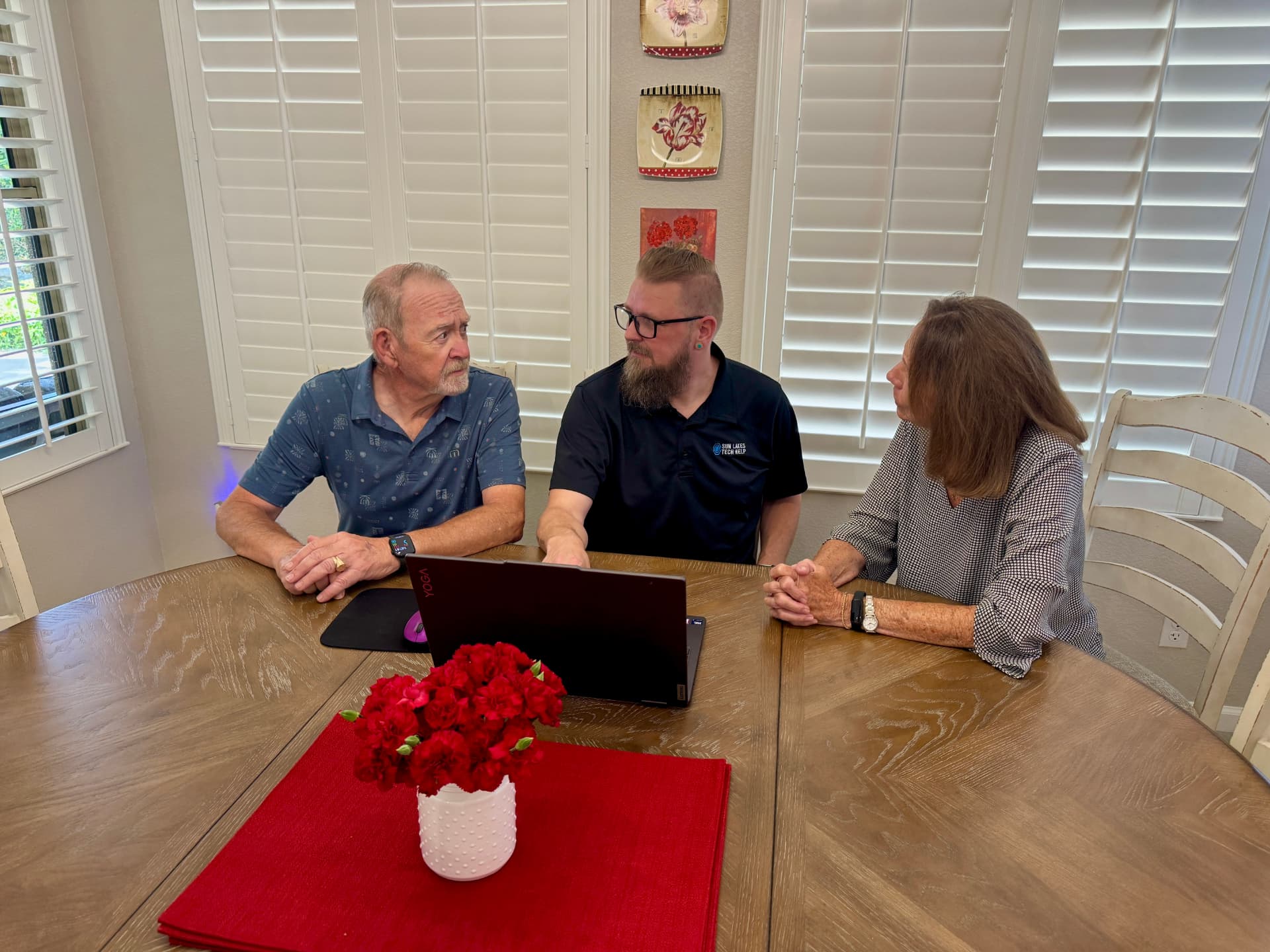 A Sun Lakes Tech Help team member listening to two neighbors during an in-home computer visit